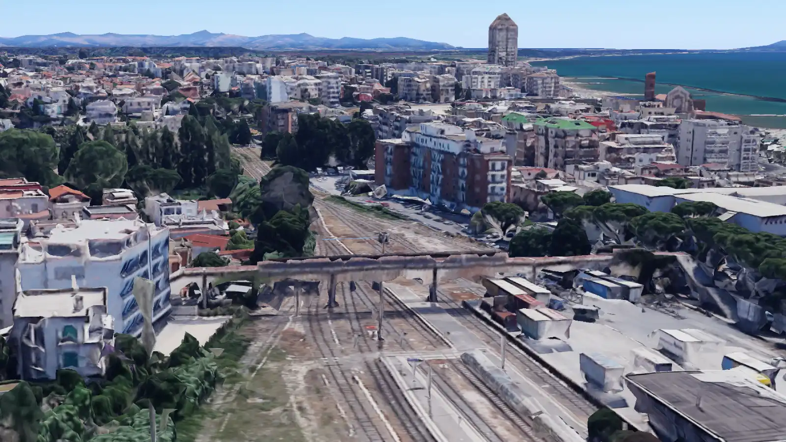 Visuale dall'alto del cavalcavia sulla linea ferroviaria che divide in due Nettuno (Google Maps 3D con ausilio AI)